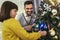 Father and Daughter Celebrating Christmas by the Tree