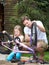 Father And Daughter Cleaning Bike Together