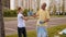 A father and daughter collect plastic garbage, they give each other a high five.