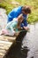 Father And Daughter Fishing In Pond With Net