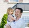 Father and Daughter in Front of House