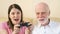 Father and daughter gamers playing video game at home.Players with remote controller of game console