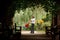 Father and daughter in garden in plant tunnel