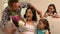 Father and daughter giving bouquet to mother