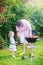 Father and daughter grilling in the garden