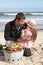 Father And Daughter Having Barbeque On Beach