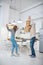 Father with daughter having fun dancing at home in kitchen.