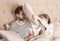 Father and daughter having pillow fight in a bed