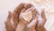 Father And Daughter Holding Heart-Shaped Dough On Hands Indoor, Closeup