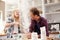 Father and daughter making a cake together