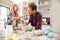 Father and daughter making a cake together