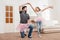 Father and daughter in pink tutu tulle skirts dancing at home
