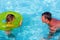 Father and daughter playing in swimming pool. Summer funny vacation
