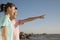 Father and Daughter pointing and looking to the sea