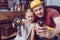 Father and daughter posing with toy drills while making a wooden frame at home