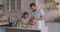 Father and daughter preparing cakes together