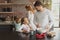 Father and daughter preparing cookie on worktop