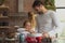 Father and daughter preparing cookie on worktop