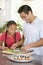 Father And Daughter Preparing Sushi Together