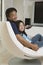 Father and Daughter preparing to watch television in living room portrait