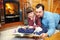 Father and daughter reading in front of fireplace