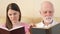 Father and daughter reading physical print books. Concept of traditional classical paper reading