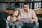 Father and daughter reading sport news and business newspapers while sitting on sofa