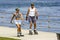 Father and daughter rollerblading together