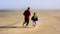 Father and Daughter Run on empty beach sand