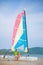 Father and daughter seat on side of catamaran sail boat on ocean