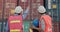 Father, daughter, and senior engineers in a shipyard visit a cargo container site