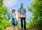 Father and daughter with shovel and watering can in garden. It is time to plant prepare beds and care for lawn. Pick out