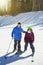 Father and daughter skiing together