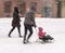 Father with daughter in a sledge ride in motion blur