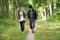 Father and daughter smiling and walking in nature