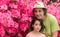 Father and daughter standing in front of pink azalea flowers in tshirt on hot spring day