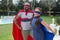 Father and daughter in superhero costume standing in garden