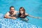 Father and daughter swimming in the poo