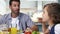 Father and daughter talking together during the lunch