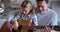 Father and daughter teaching, playing guitar and learning musical notes at home. Happy, loving and caring dad and girl