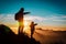 Father and daughter travel in mountains at sunset, family pointing at sky