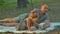 Father and daughter waits a mother with basket and food on picnic in forest