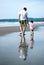 Father and daughter walking on the beach