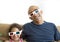 Father and daughter watching television in 3D