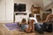 Father And Daughter Watching Television In Playroom Together