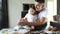 Father and daughter in white T-shirts cooking in modern kitchen.