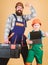 Father and daughter in workshop. Repair. Childrens creativity. Repairman in uniform. Engineer. Bearded man with little