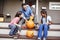 Father And Daughters Carving Halloween Pumpkin On House Steps