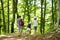 Father and daughters following a footpath around La Verna Sanctuary, Chiusi della Verna, in Casentino secular forest, one of the