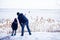 Father with daugther watching frozen river with snow around